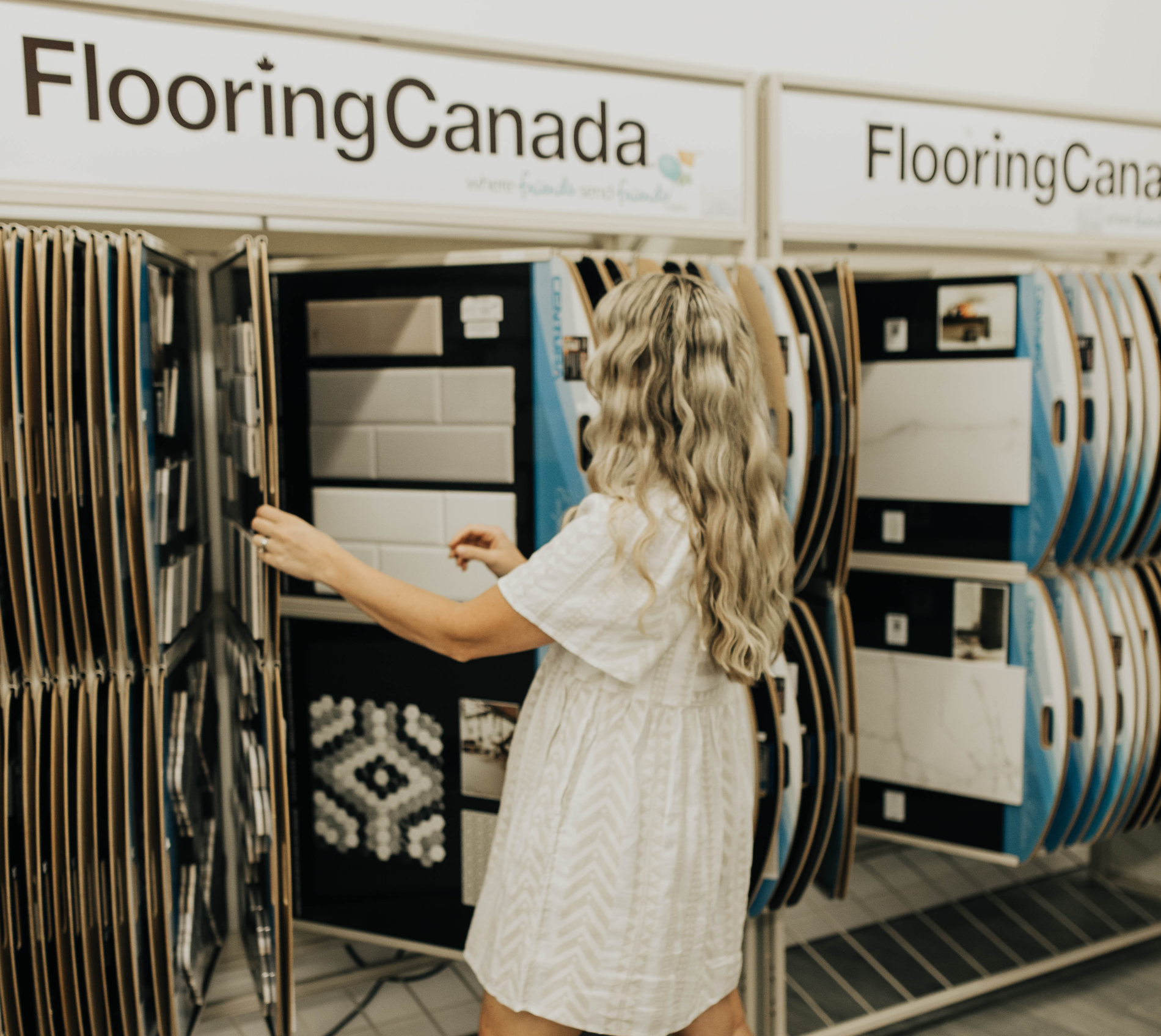 Women holding flooring sample in floor store 